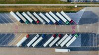 Distribution trucks in a parking lot.