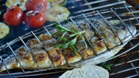 Fish and vegetables being roasted on the grill