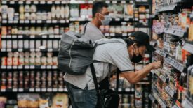 A man looking at labels while grocery shopping