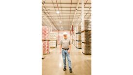 Person Standing in Warehouse