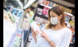 Woman reading milk label